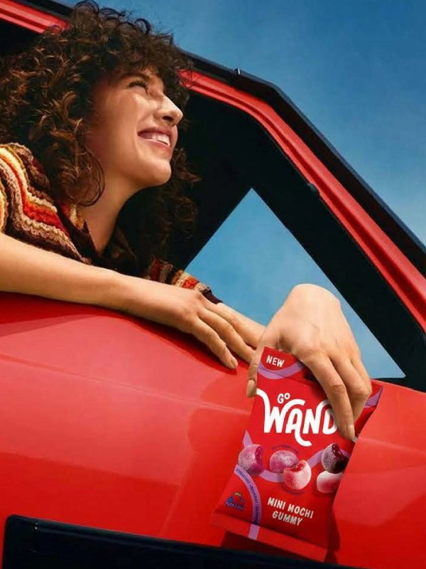 woman in a car holding go wandr product